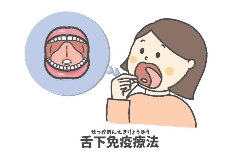 ピンク色のカプセル薬とコップに水が入った写真